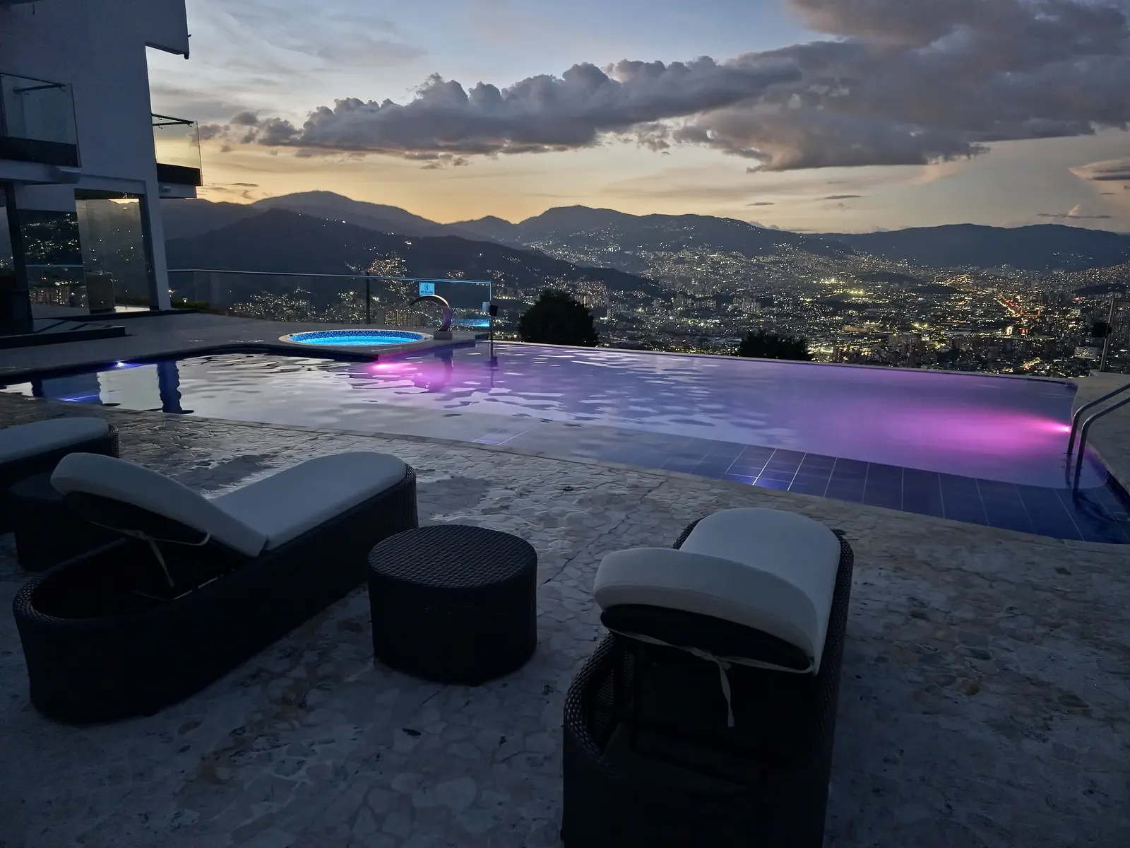 Nomad Finca's heated infinity pool overlooking the Medellín valley at dusk